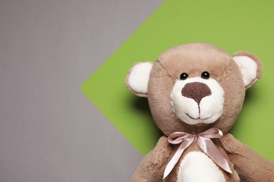 Cute teddy bear on color background, top view. Space for text