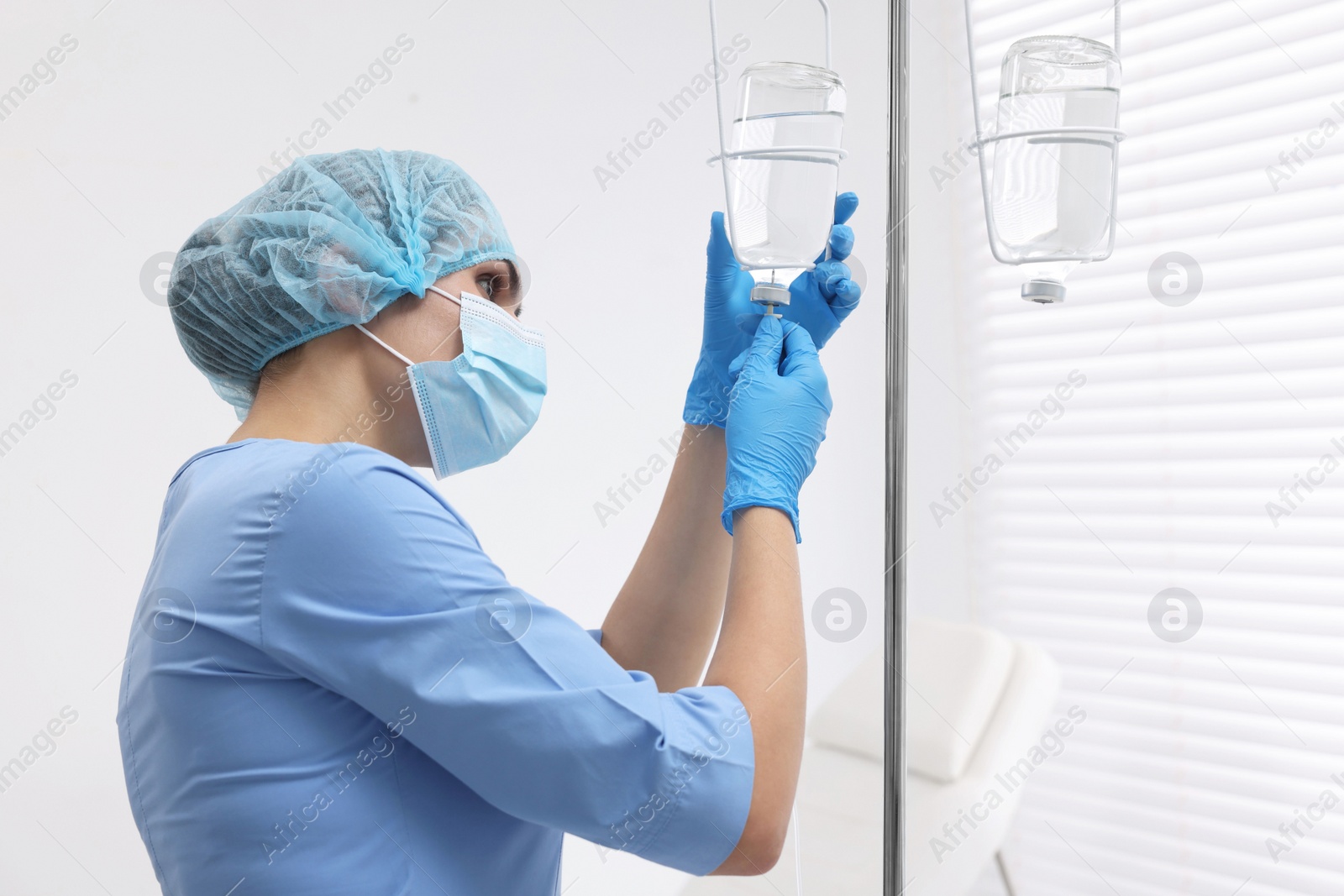 Photo of Nurse setting up IV drip in hospital