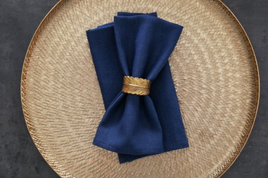 Photo of Tray with blue napkins and decorative ring on grey table, top view