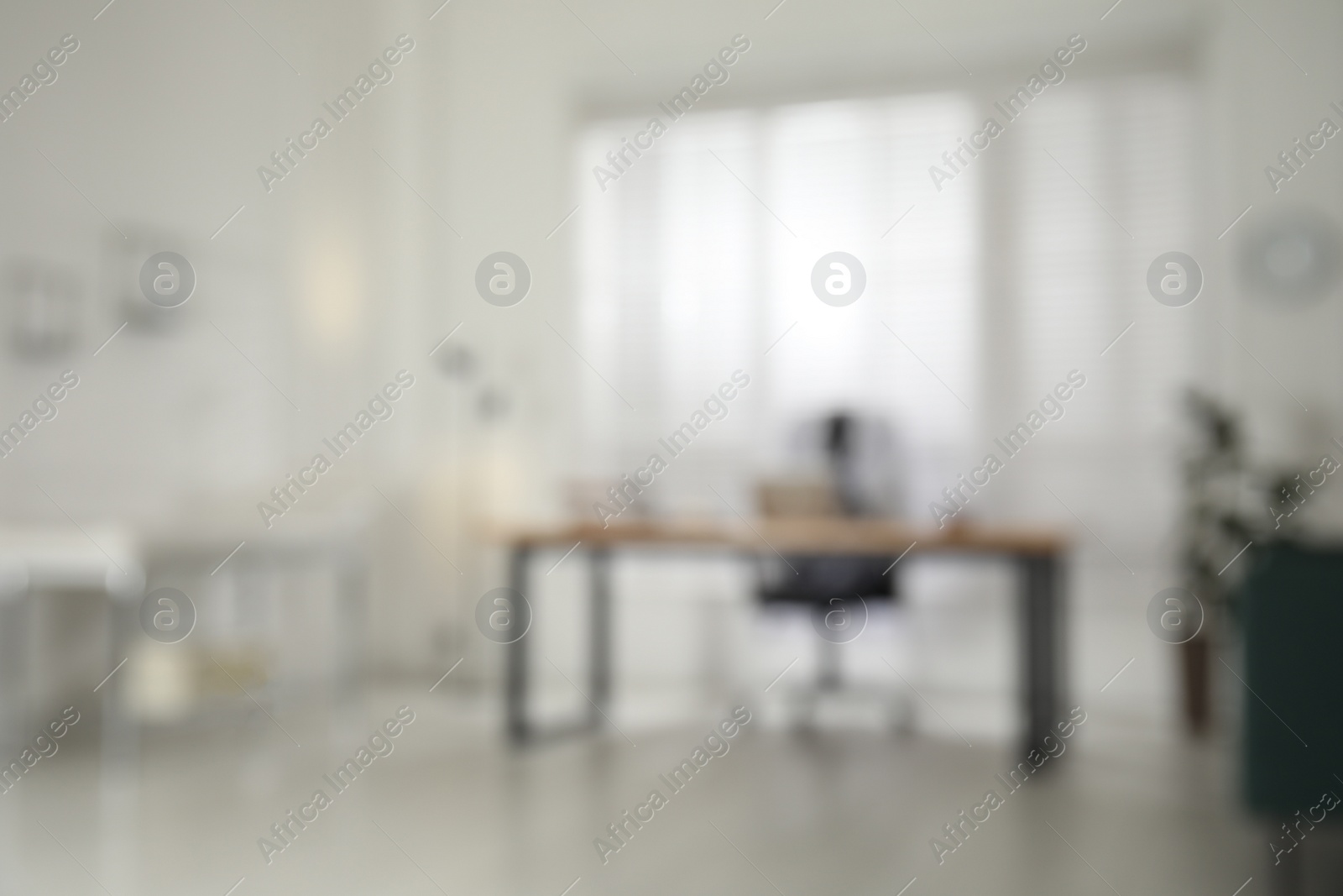 Photo of Blurred view of modern medical office with doctor's workplace. Interior design