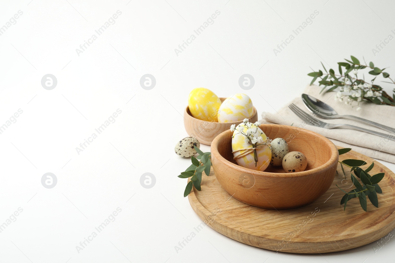 Photo of Festive Easter table setting with eucalyptus and eggs. Space for text