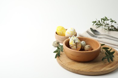 Festive Easter table setting with eucalyptus and eggs. Space for text