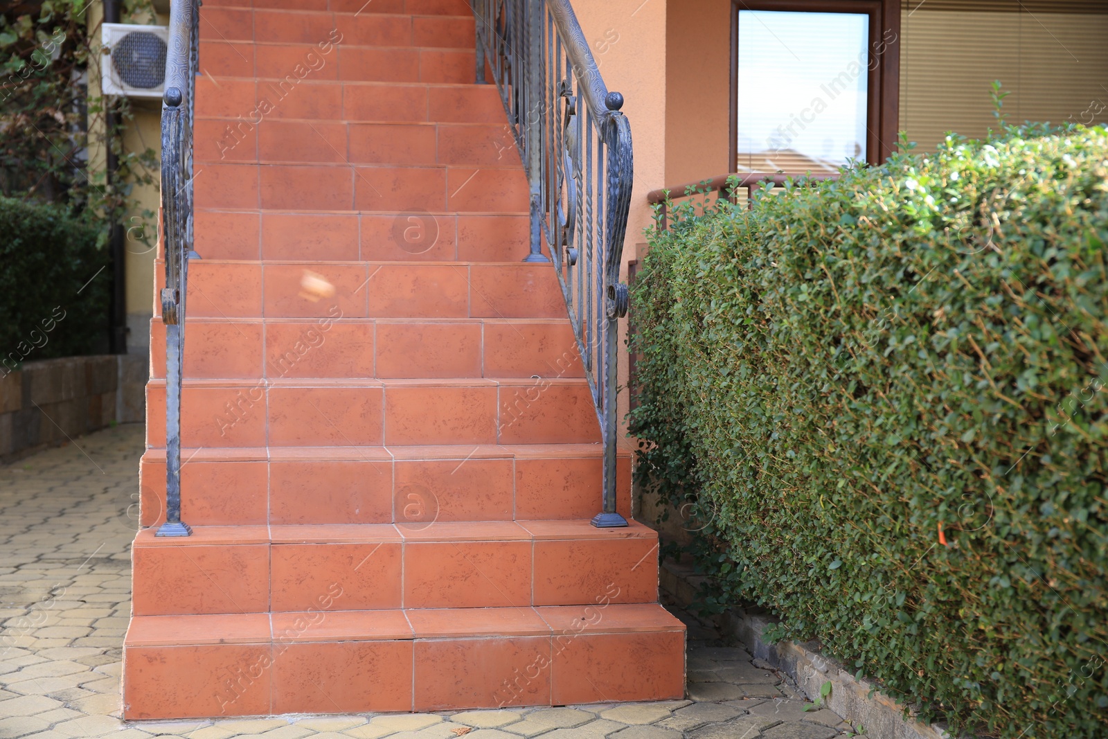 Photo of View of beautiful stairs with metal handrails near house outdoors