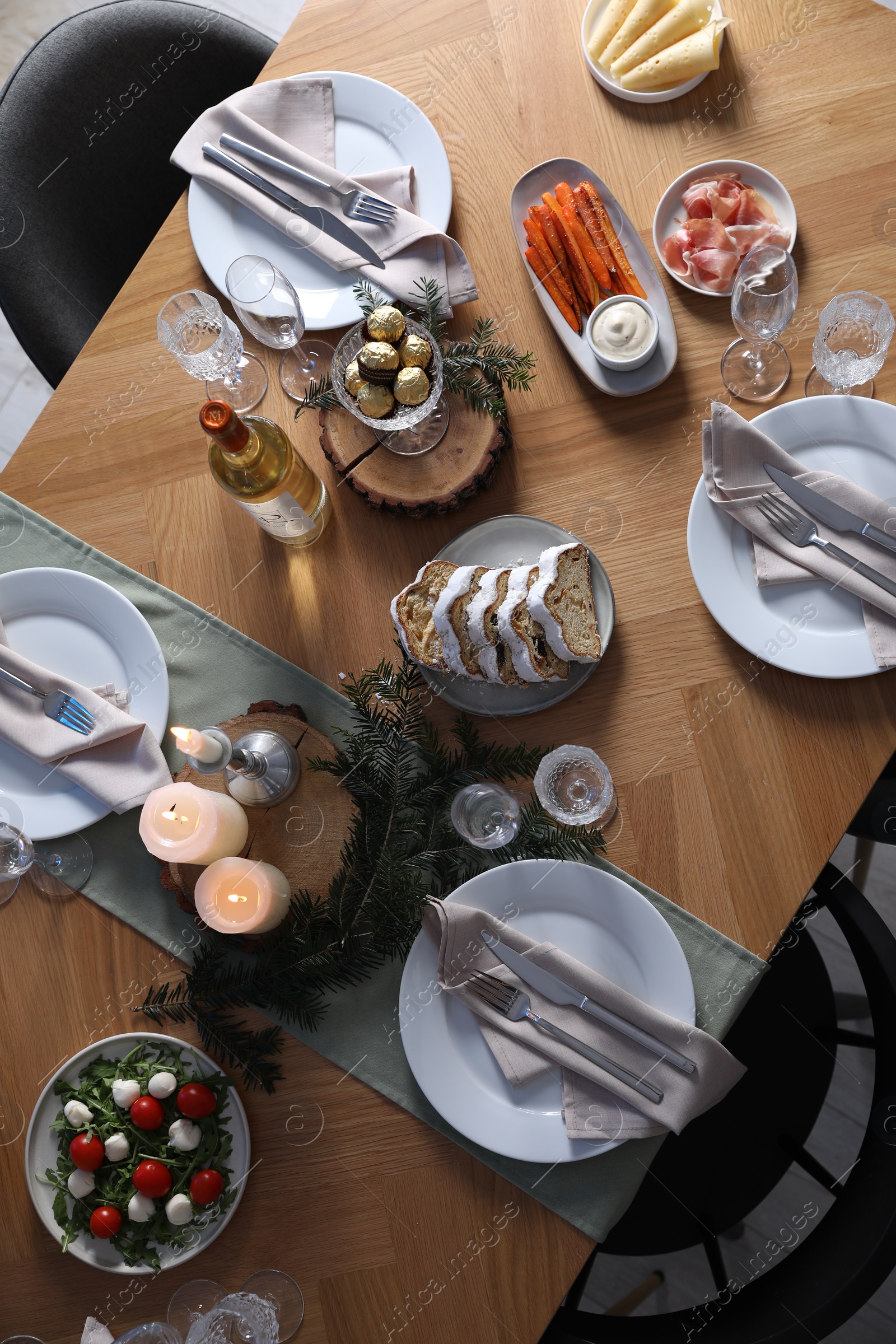 Photo of Christmas table setting with festive decor and dishware, top view