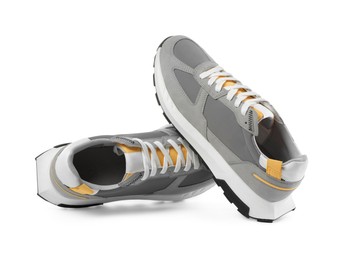 Pair of stylish grey sneakers isolated on white