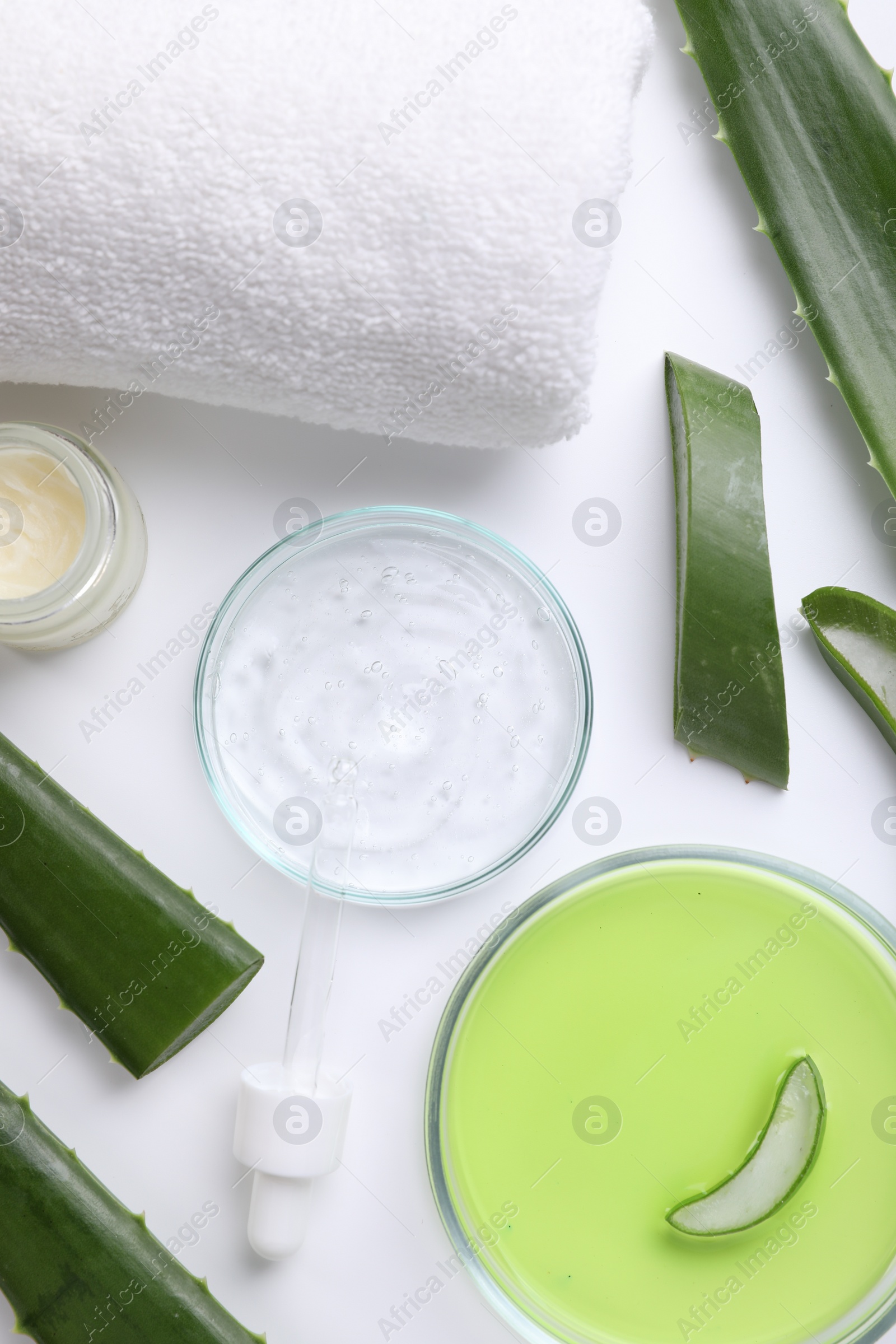 Photo of Flat lay composition with cosmetic products and cut aloe leaves on white background