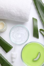 Flat lay composition with cosmetic products and cut aloe leaves on white background