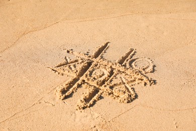 Photo of Tic tac toe game drawn on sandy beach