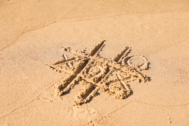 Tic tac toe game drawn on sandy beach