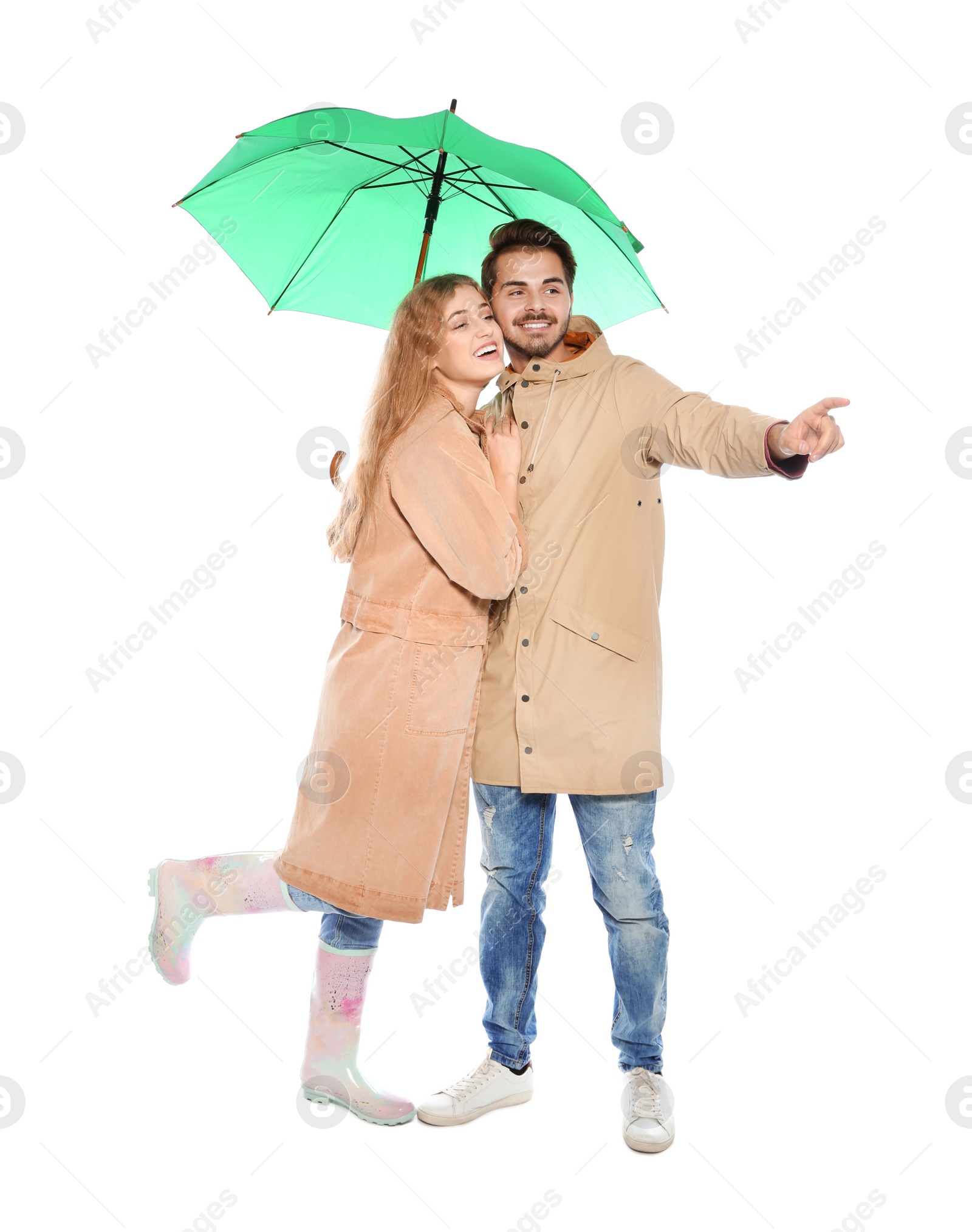 Photo of Young romantic couple with bright umbrella on white background