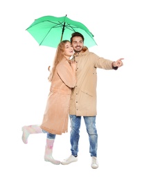 Photo of Young romantic couple with bright umbrella on white background