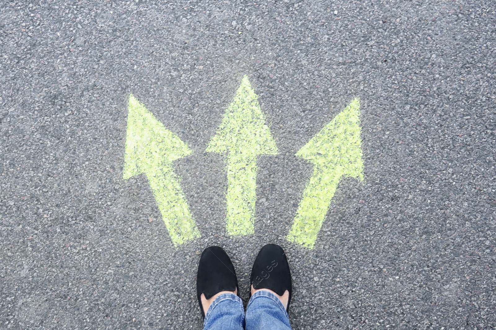 Photo of Woman standing on road near arrows marking, closeup