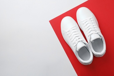 Photo of Pair of sneakers on color background, flat lay. Space for text