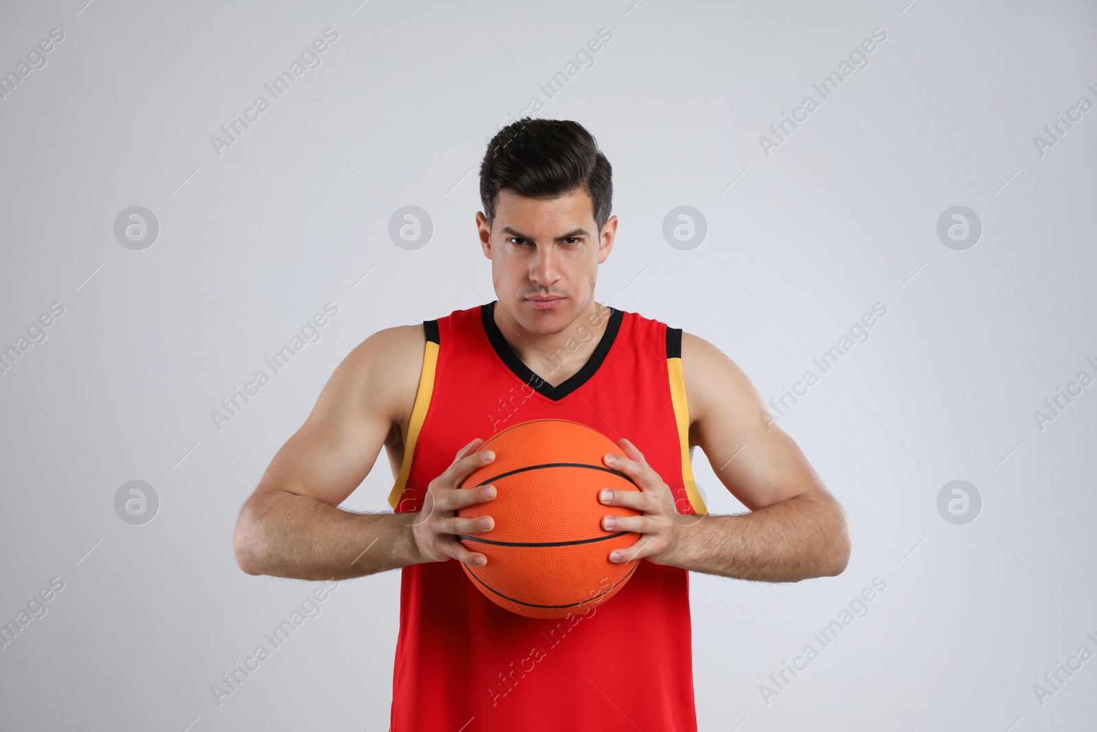 Photo of Basketball player with ball on grey background