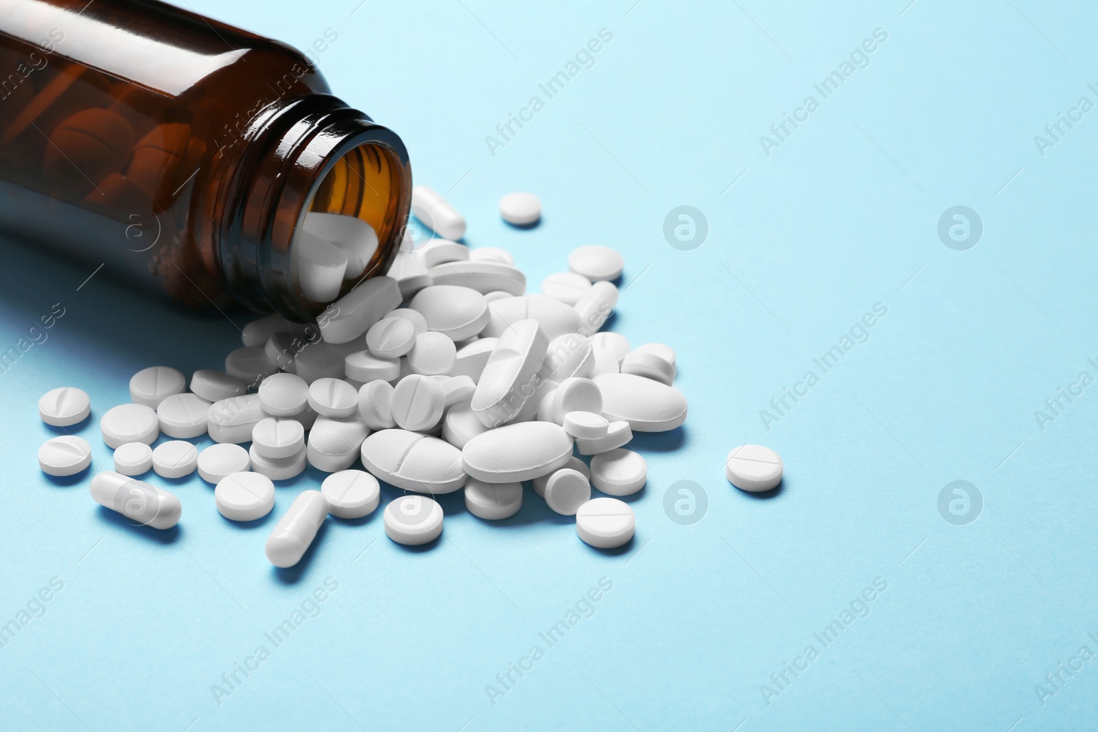 Photo of Bottle with vitamin pills on color background. Space for text