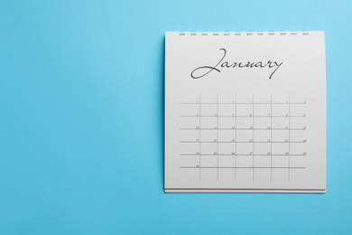 January calendar on light blue background, top view. Space for text