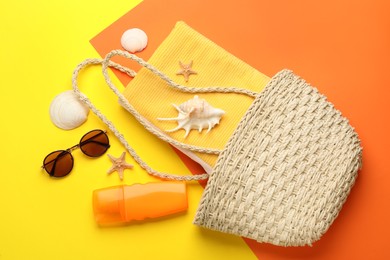 Photo of Stylish bag and beach accessories on color background, flat lay