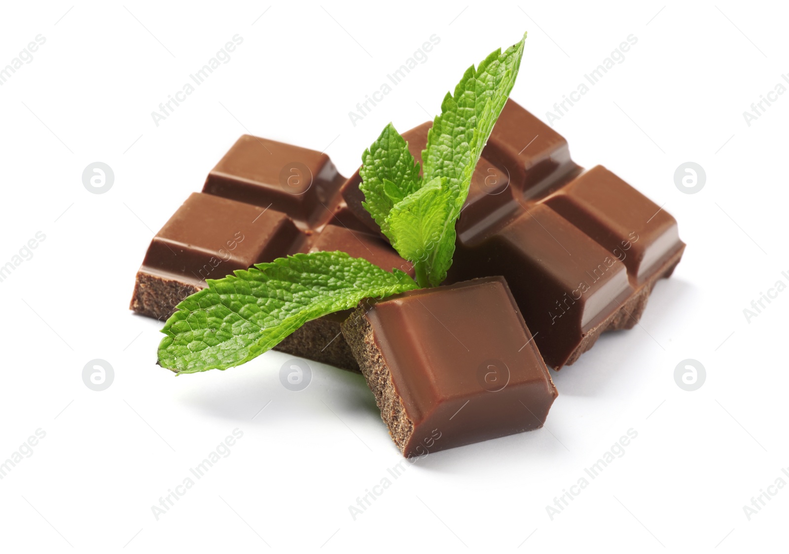 Photo of Pieces of milk chocolate with mint on white background