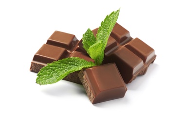 Pieces of milk chocolate with mint on white background