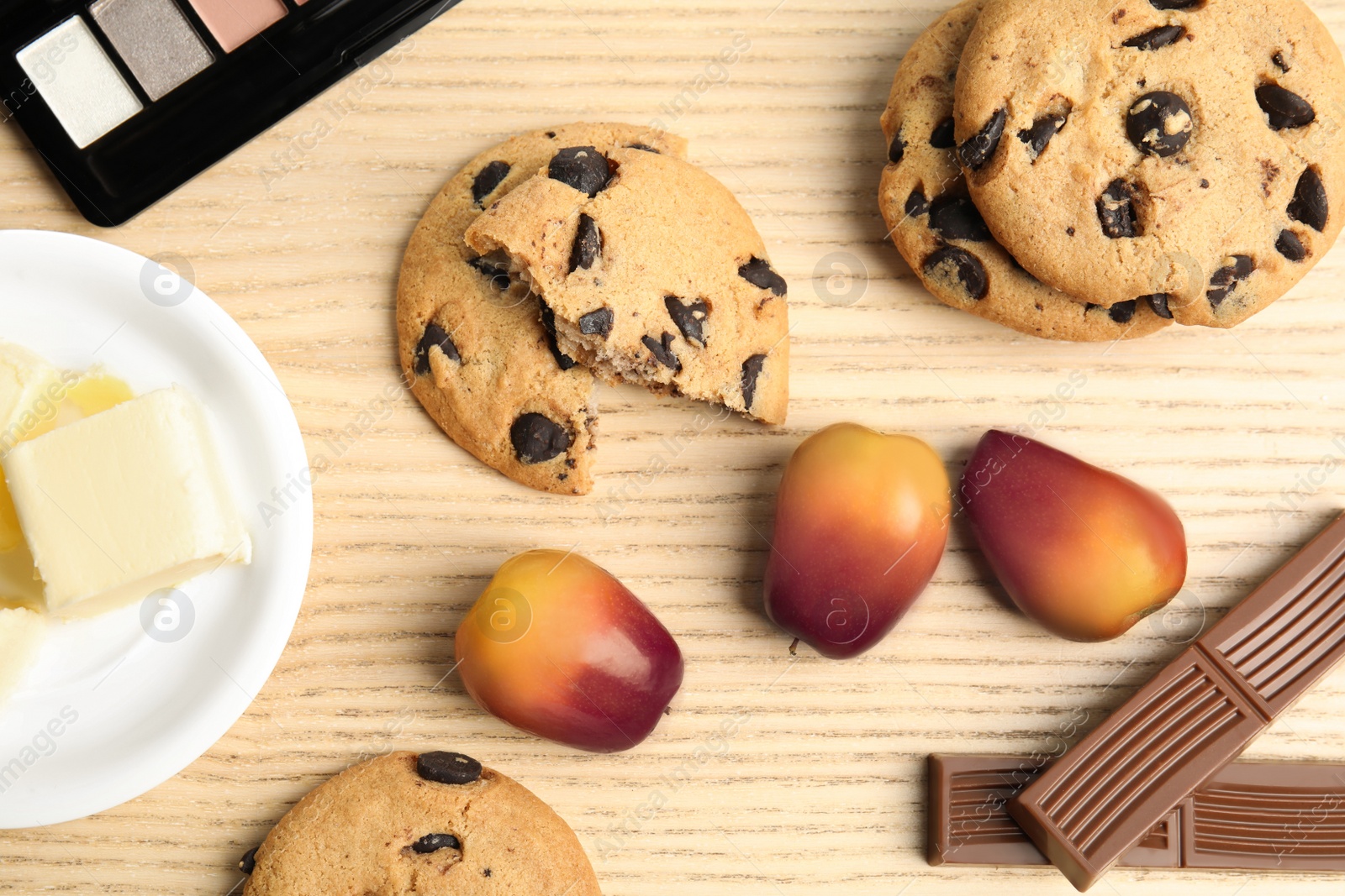 Image of Palm oil fruits, sweets and butter on wooden table, flat lay