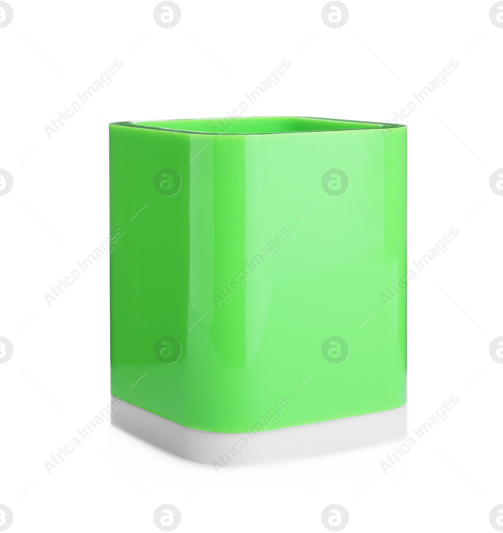 Photo of Green plastic holder isolated on white. Stationery for school