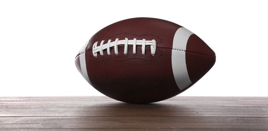 Photo of American football ball on wooden table against white background