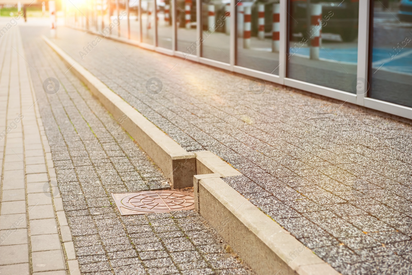 Photo of View on grey stone sidewalk. Footpath covering