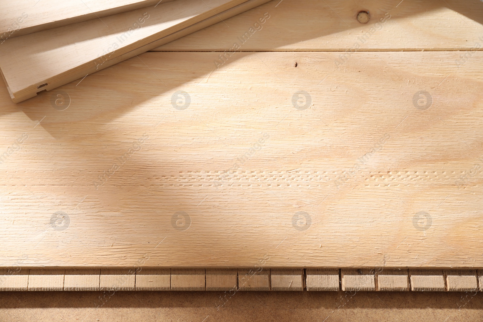 Photo of Wooden planks prepared for polishing with coarse sandpaper, top view