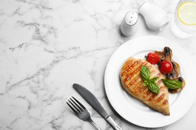 Tasty grilled chicken fillet served on white marble table, flat lay. Space for text