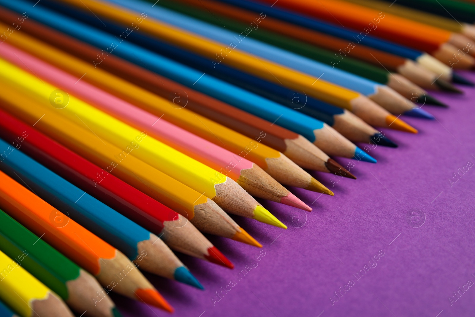 Photo of Composition with color pencils on purple background