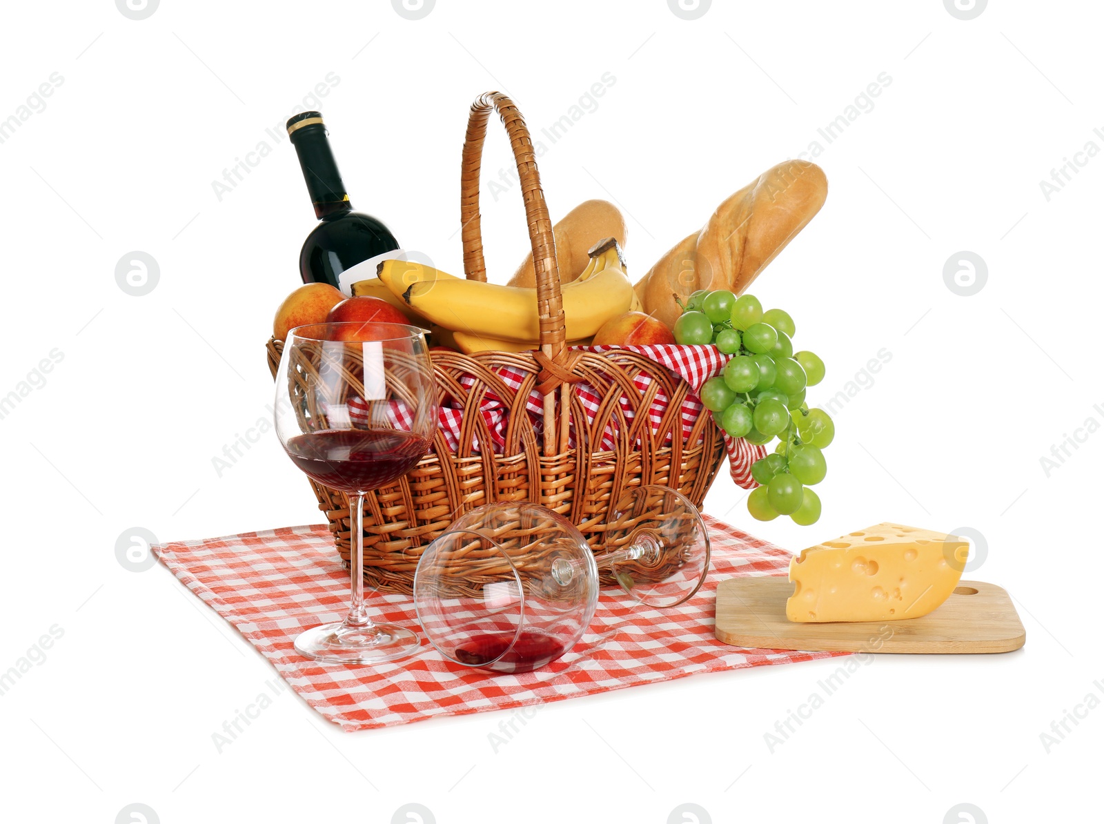 Photo of Picnic basket with food and glasses of wine on white background