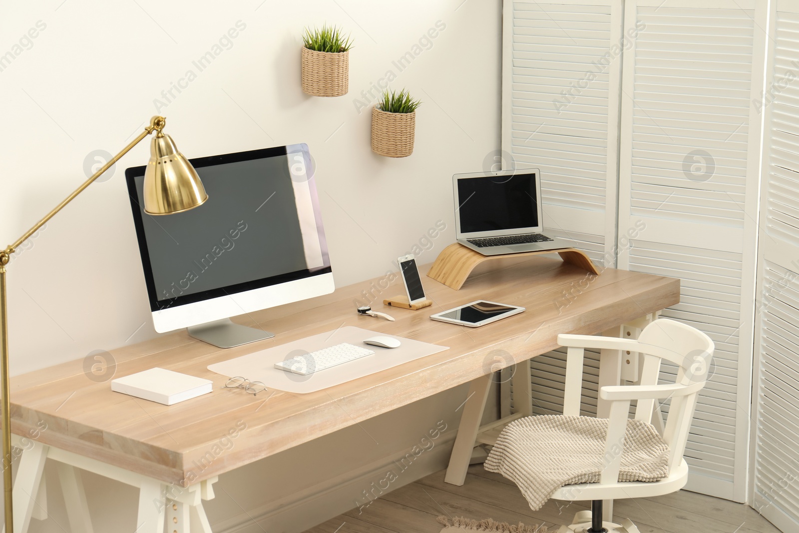 Photo of Stylish workplace interior with modern computer on table. Mockup for design