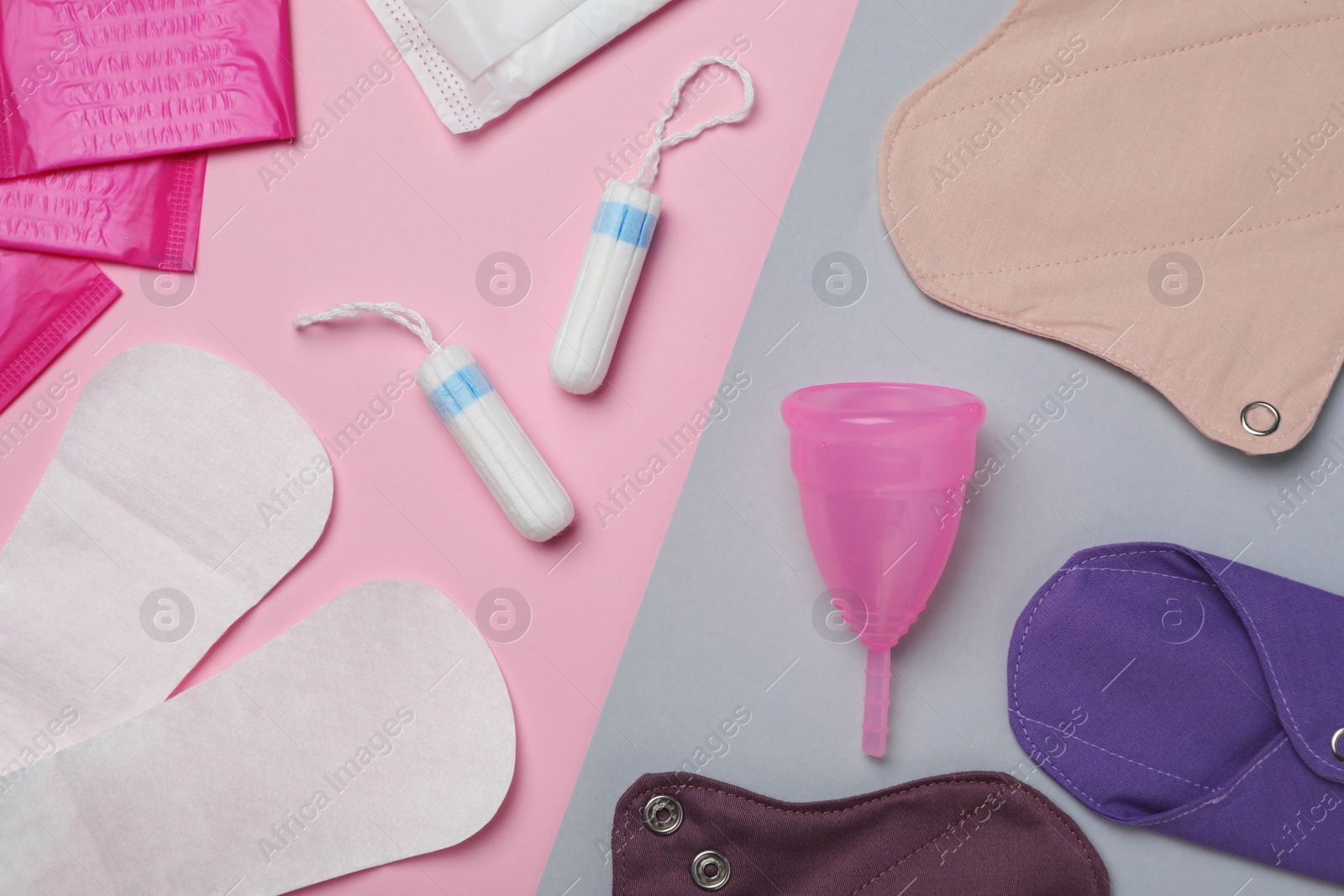 Photo of Reusable and disposable menstrual hygiene products on color background, flat lay