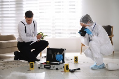 Photo of Investigators working at crime scene in living room