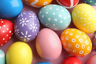 Photo of Many colorful painted Easter eggs as background, top view