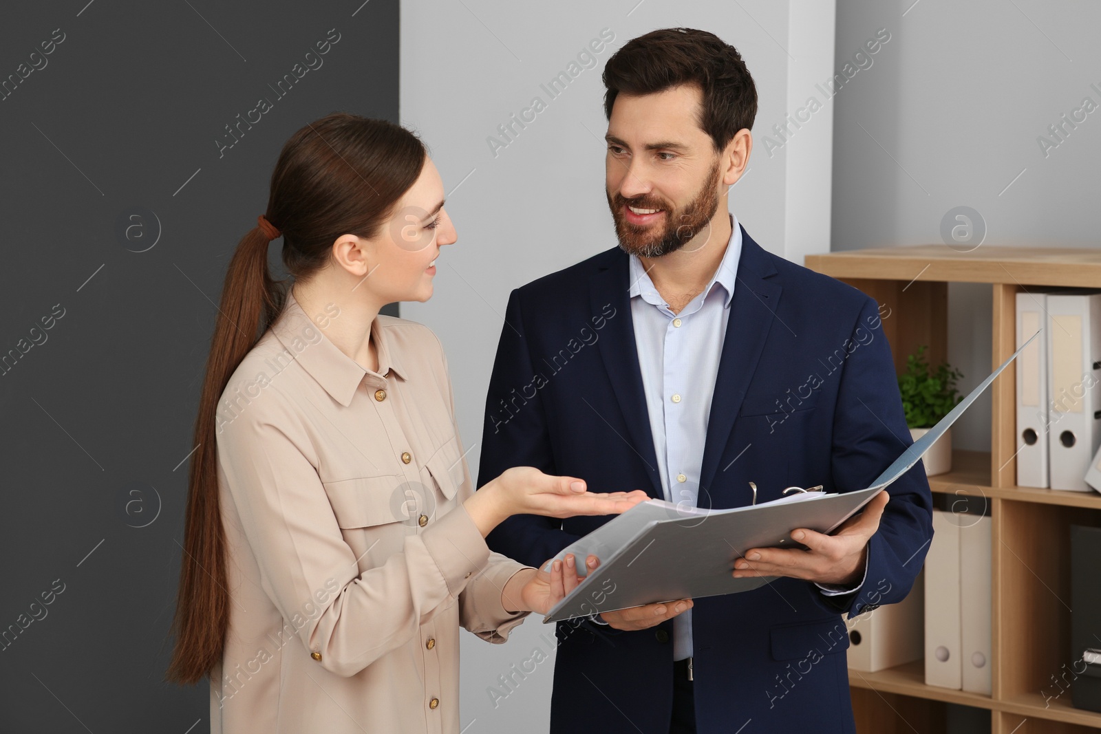 Photo of Businesspeople working together with documents in office