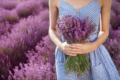 Young woman with bouquet in lavender field
