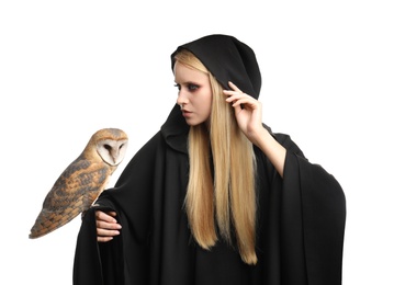 Photo of Witch in black mantle with owl isolated on white. Scary fantasy character