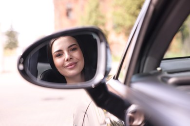 Photo of Woman with safety seat belt driving her modern car