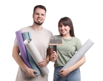 Photo of Couple with wallpaper rolls and brush on white background