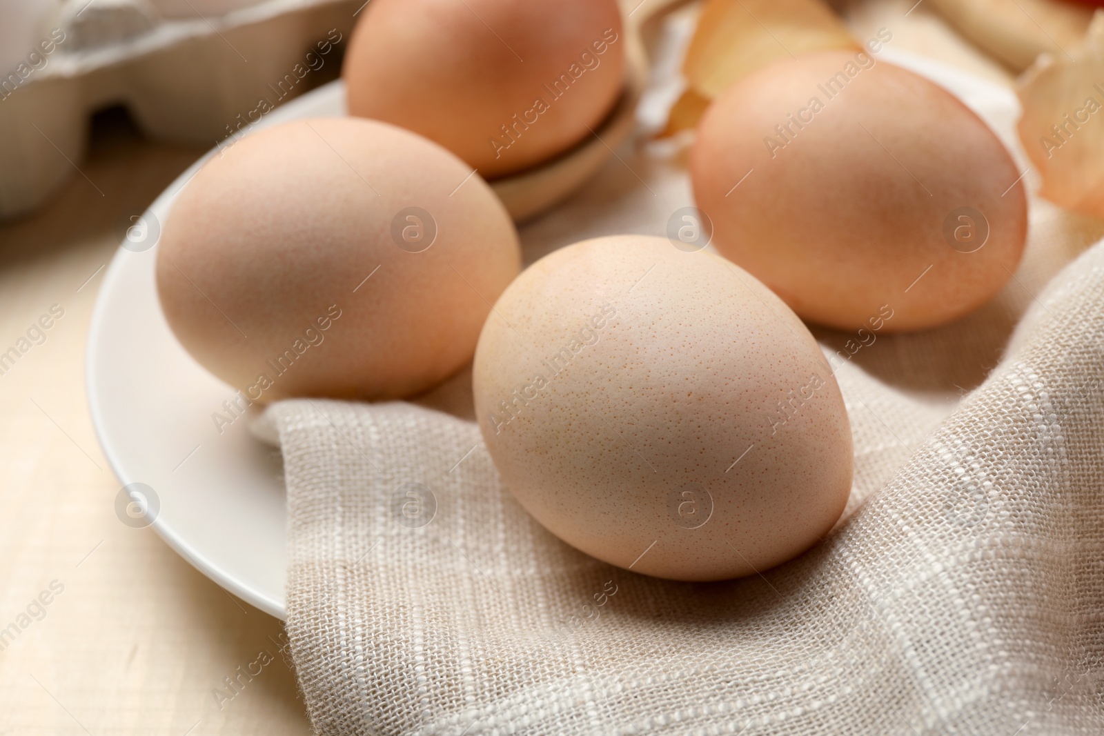 Photo of Easter eggs painted with natural dye on table, closeup