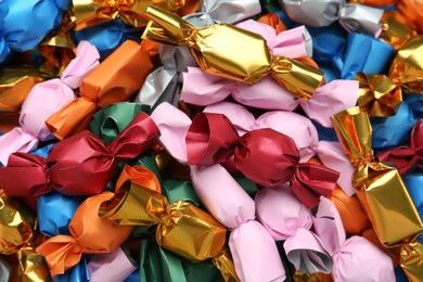 Many candies in colorful wrappers as background, closeup