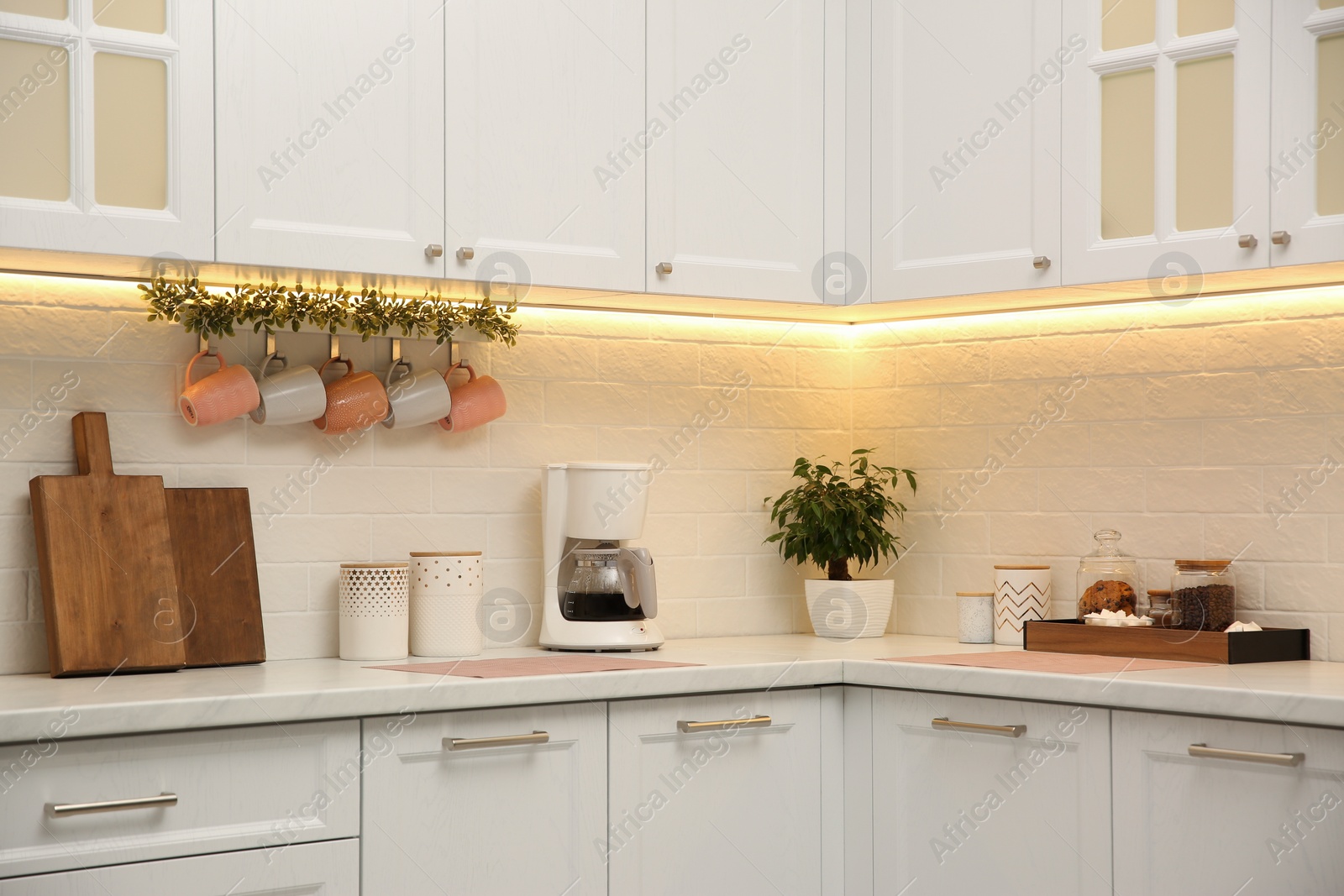 Photo of Stylish kitchen interior with modern coffeemaker on countertop