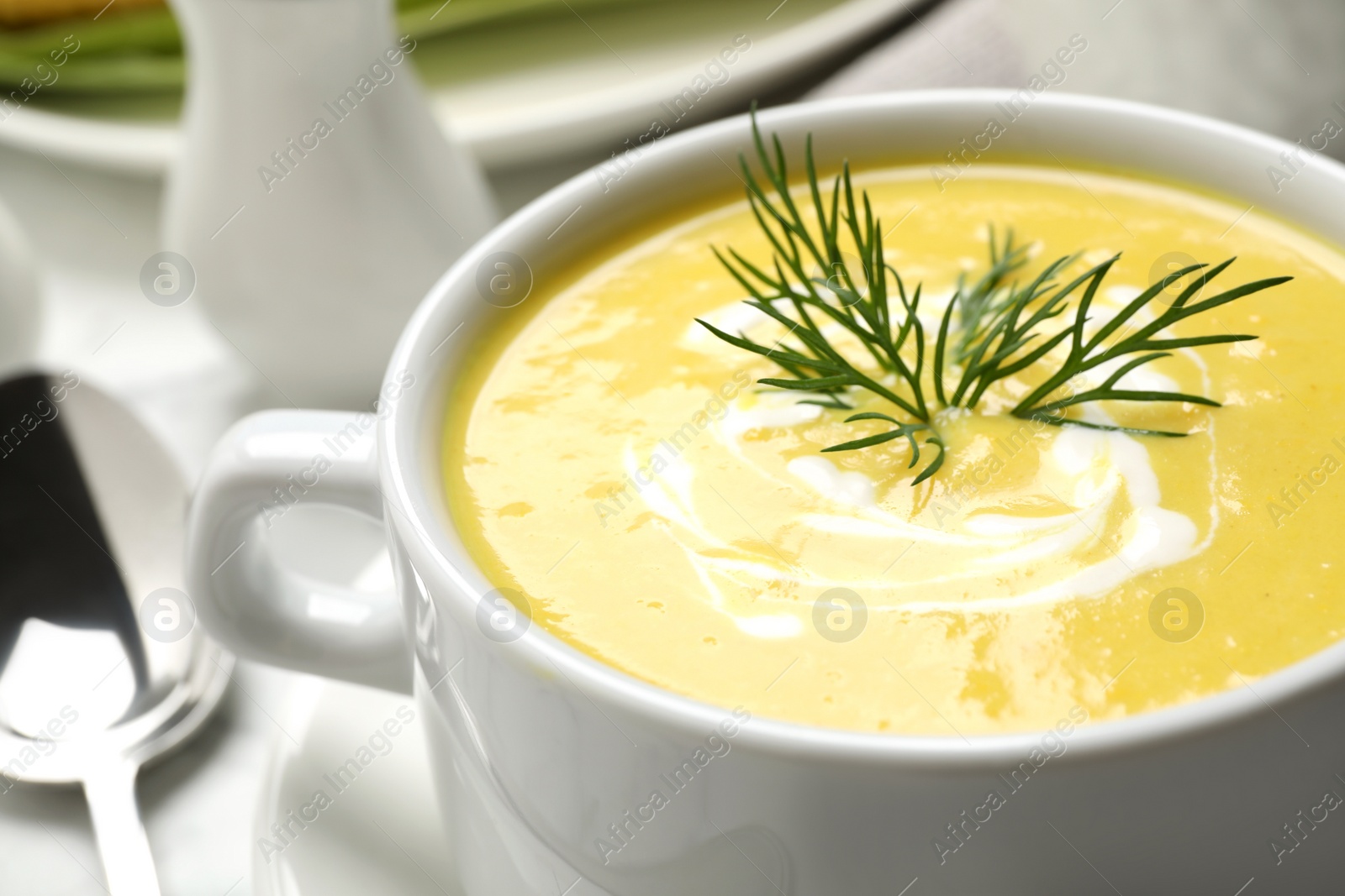 Photo of Delicious creamy corn soup on table, closeup