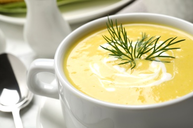 Photo of Delicious creamy corn soup on table, closeup