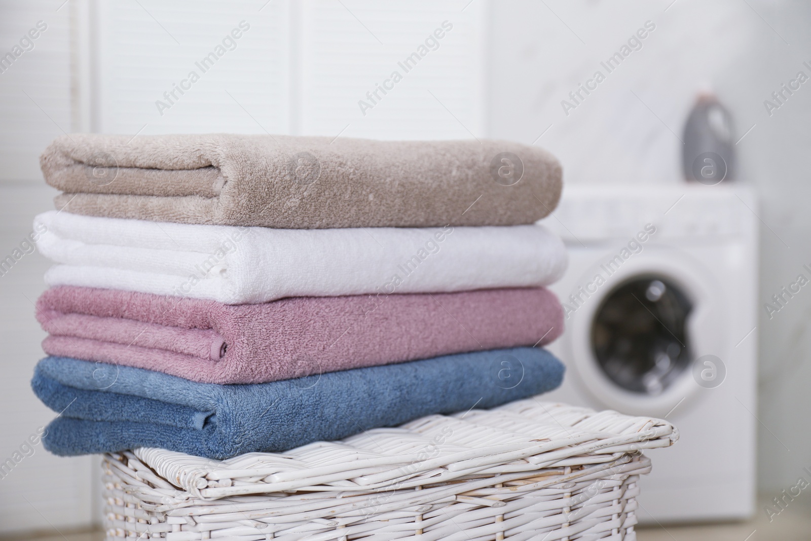 Photo of Stack of fresh towels in laundry room