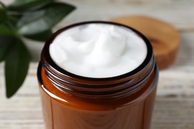 Photo of Jar of face cream on white table, closeup