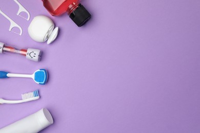 Photo of Flat lay composition with tongue cleaner and teeth care products on violet background, space for text