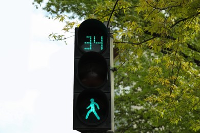 Photo of Modern traffic light with timer in city