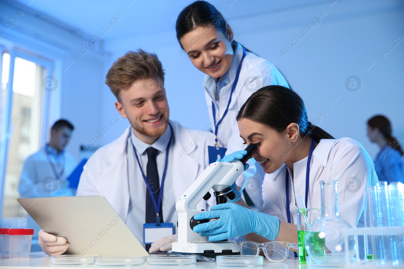 Photo of Group of scientists working in modern chemistry laboratory